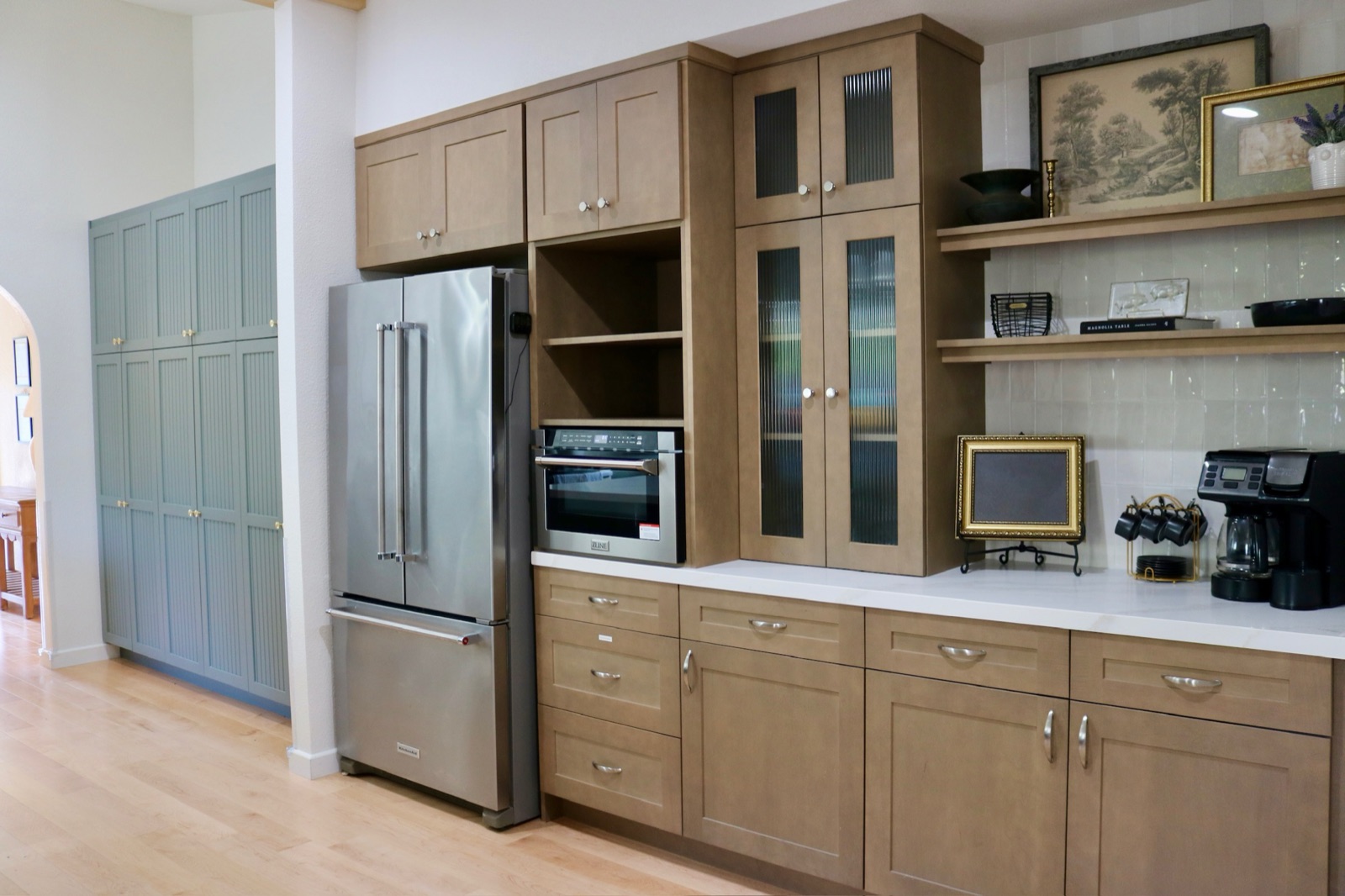 Coffee and beverage nook with warm wood cabinetry and a coffee maker