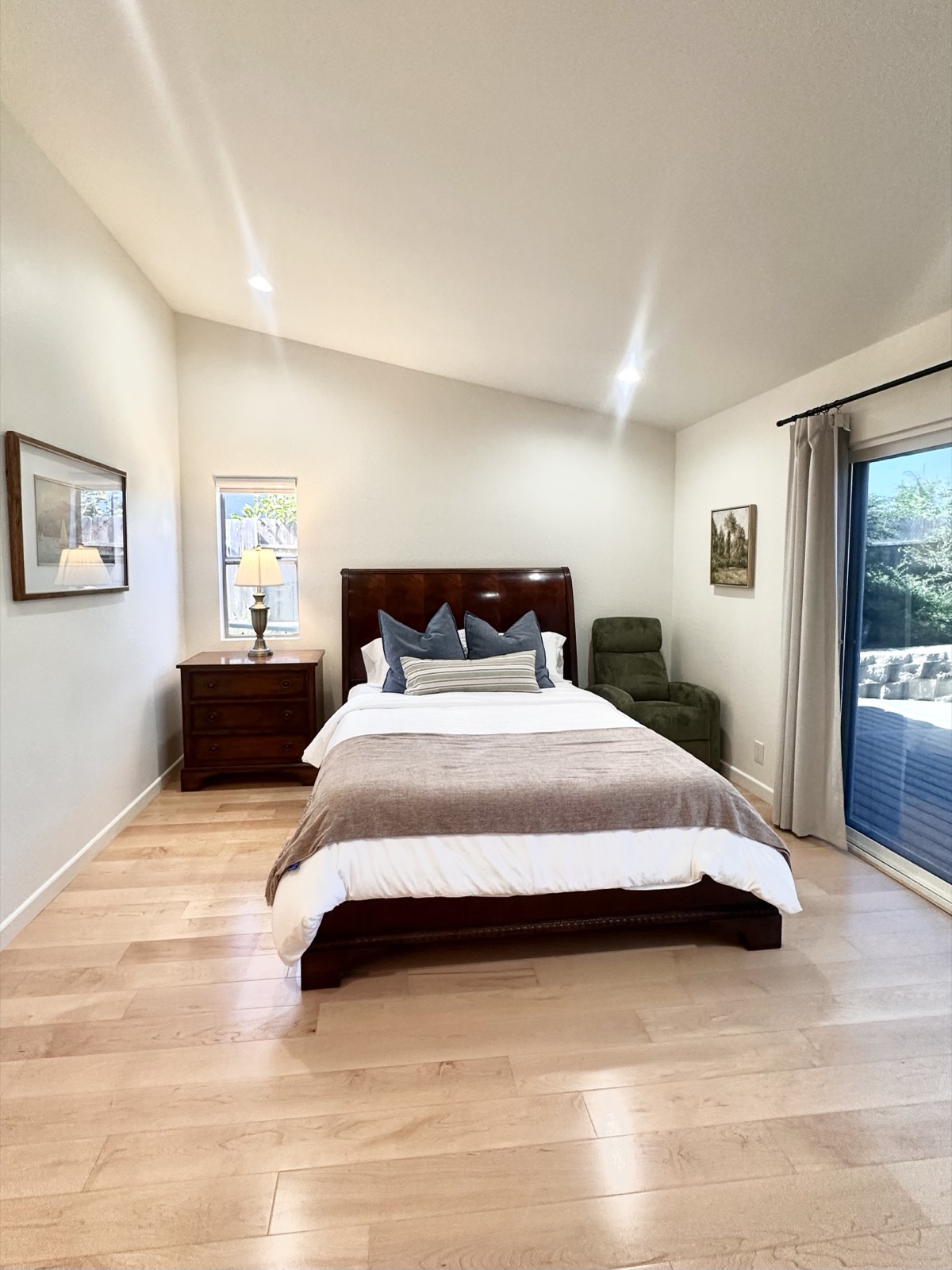 Private resident bedroom with natural light and a lit bedside lamp